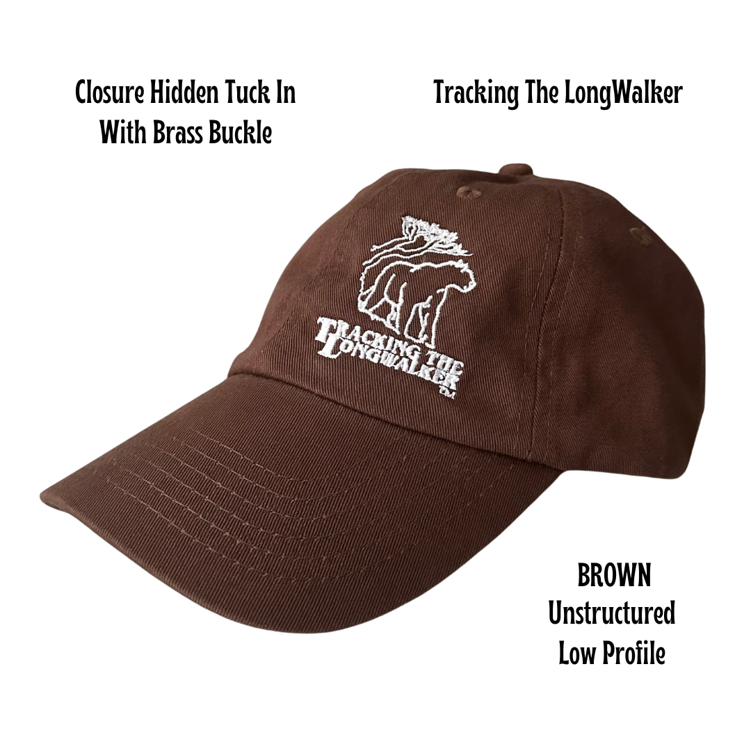A brown, low-profile unstructured cap with an embroidered design featuring the mountain lion logo, and text 'TRACKING THE LONGWALKER WITH BRass BUCKLE'. Cap is Unisex and can be worn by adults and children.