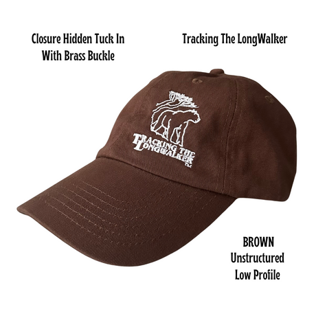 A brown, low-profile unstructured cap with an embroidered design featuring the mountain lion logo, and text 'TRACKING THE LONGWALKER WITH BRass BUCKLE'. Cap is Unisex and can be worn by adults and children.