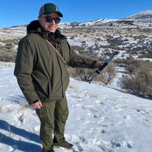 Load image into Gallery viewer, Man in winter attire showing the folded up Beamer antenna. 