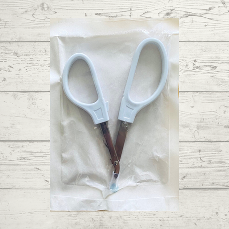 A sterile, single skin stapler remover scissor